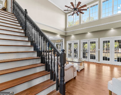 Bright home interior with staircase and windows